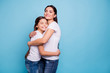 © deagreez - Close up photo adorable amazing pretty two people brown haired mum small little daughter stand close eyes closed holding hands arms circle wearing white t-shirts isolated on bright blue background