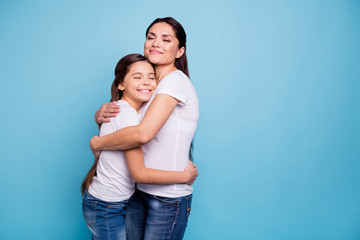 Canvas Print - Close up photo adorable amazing pretty two people brown haired mum small little daughter stand close eyes closed holding hands arms circle wearing white t-shirts isolated on bright blue background