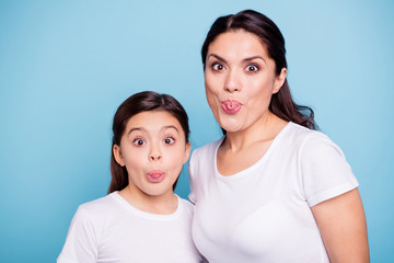 Poster - Close up photo beautiful two people brown haired mom little daughter friends look silly eyes opened tongue out of mouth straw shape figure playing wear white t-shirts isolated bright blue background