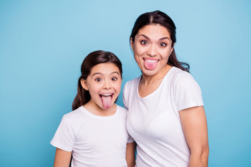 Poster - Close up photo beautiful two people brown haired mom little daughter friends hipsters silly mouth opened tongue out fooling around playing wear white t-shirts isolated bright blue background