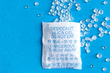 Pouch With Silica Gel Unfolded On Blue Background
