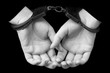 Girl's hands in handcuffs on black background. arrest, detention of the criminal. prison.