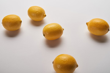 yellow ripe whole scattered lemons on grey background