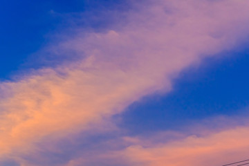 Wall Mural - Beautiful red, orange and yellow clouds and blue sky background. Colorful exotic sky with orange clouds and blue sky on background