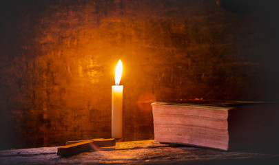 Canvas Print - Candle with holy bible and cross on wooden table. christian concept.