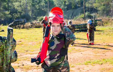 Wall Mural - Boy paintball player in camouflage standing with gun before playing outdoors