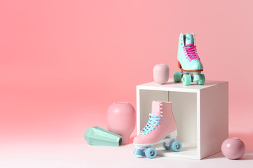 Wall Mural - composition with vintage roller skates and storage cube on color background. space for text