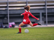 Young high school girl competing in a soccer match
