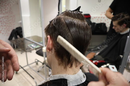 Master Hairdresser Does Hairstyle And Style With Scissors And Comb