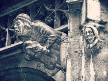 Gargoyle Riding A Goat And A Witch Head  On The Facade Of A Building In The Town Hall Yard Of Munich  In Neo-Gothic Style