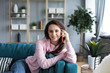 © BestForYou - Attractive young woman talking on mobile phone and smiling while sitting on sofa at home.