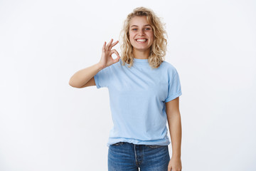 Wall Mural - Perfect, totally love it. Happy and pleased delighted female customer with blond short hairstyle and satisfied joyful grin showing okay gesture and smiling at camera reacting to excellent work