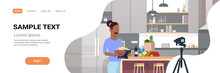 Girl Food Blogger Recording Video On Camera African American Woman Preparing Tasty Dish Modern Kitchen Interior Cooking Blog Concept Female Character Portrait Flat Copy Space Horizontal