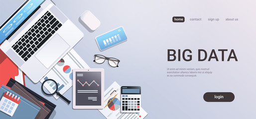 Wall Mural - big data concept workplace desk with office stuff top angle view tablet laptop computer paper docume