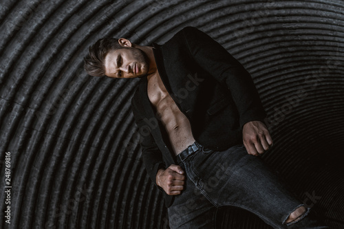 Cuadros en Lienzo Muscular young man with beard on dark tunnel urban background