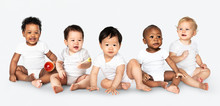 Diverse Babies Sitting On The Floor