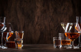 Fototapeta Mapy - Selection of hard strong alcoholic drinks in big glasses and small shot glass in assortent: vodka, cognac, tequila, brandy and whiskey, grappa, liqueur, vermouth, tincture, rum. 