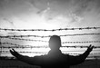 social justice abstract concept: with blurry barbed wire rod fence