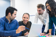 © NicoElNino - Group of business people discussing ideas and strategy in meeting room, smiling woman, multiple ethnicity, leadership, computer on office table