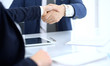 © rogerphoto - Group of business people or lawyers shaking hands finishing up a meeting , close-up. Success at negotiation and handshake concepts