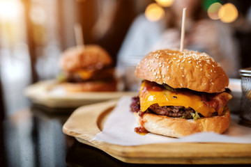 Close up of delicious burger on plate. Unhealthy eating concept.