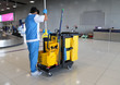Closeup of woman cleaning worker doing her work with janitorial, cleaning equipment and tools.