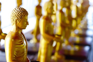 row gold buddha image in the temple