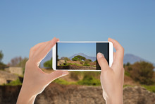 A Man Is Making A Photo Of Pompeian Landscape On A Summer Sunny Day With Vesuvius In The Background On A Mobile Phone