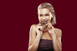 © Viacheslav Yakobchuk - Slim appealing woman eating sweet chocolate doughnut