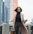 © Astroid - smiling middle aged brunette in the business district of the city