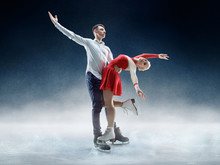 Professional Man And Woman Figure Skaters Performing Show Or Competition On Ice Arena