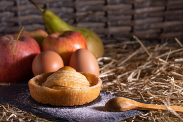 Poster - homemade apple pie on a wooden table with fruit in the background