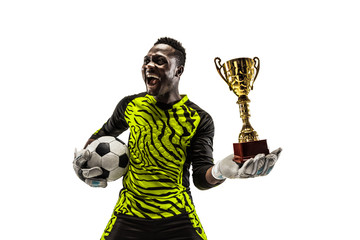 The celebrating soccer player with ball and cup isolated on white background. Competition winner concept