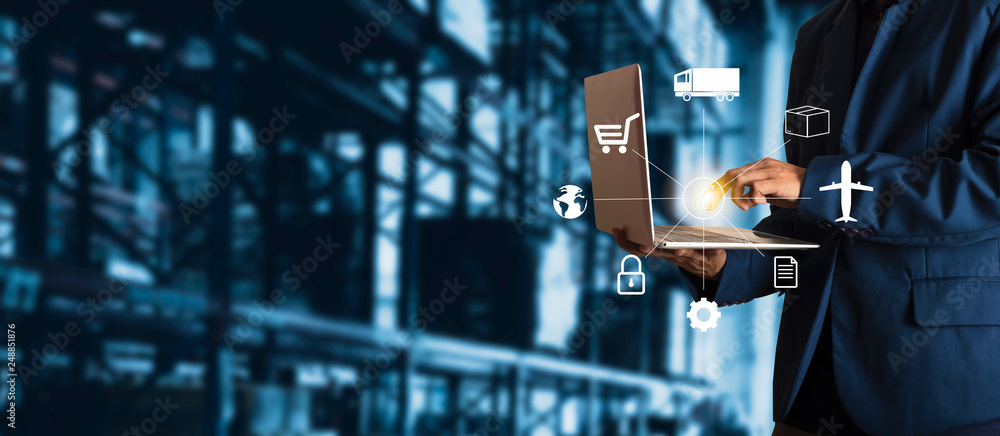 Businessman manager using laptop check orders online goods worldwide for network with Modern Trade warehouse logistics. Industry of logistics network concept. - obrazy, fototapety, plakaty 