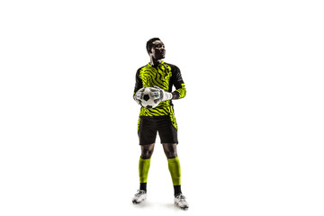 One african male soccer player goalkeeper standing and holding ball. Silhouette isolated on white studio background