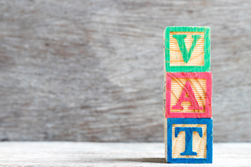 Sticker - Color letter block in word vat (abbreviation of value added tax)  on wood background