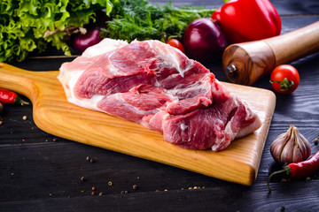 Wall Mural - Raw pork meat. Fresh steaks tenderloin on wooden cutting board