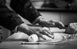  Closeup photo of baker making dough for bread. Hands of an old woman at work with the dough. Retro look.  Black and white photo of the hands of a woman