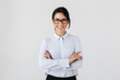 © Drobot Dean - Photo of pretty businesslike woman wearing eyeglasses standing in the office, isolated over white background