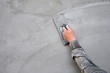 Plasterer man hand using trowel to plastering cement on concrete wall 