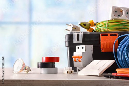 Fotomural Composition with electrical material on a table and window background