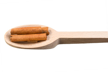 cinnamon sticks on wooden spoon isolated on white background