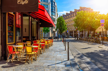 Cozy street with tables of cafe in Paris, France