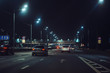 © DedMityay - Urban city traffic cars in night illuminated asphalt city road, abstract cityscape transportation concept