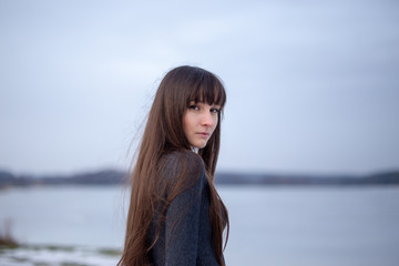 Woman beauty, body care. Beauty woman face portrait. On the ice lake 