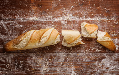 Poster - sliced bread on a wooden table. fresh baking concept