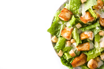 Caesar salad with lettuce,chicken and croutons isolated on white background. Top view. Copyspace