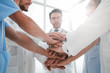 © ASDF - group of doctors with their hands folded together