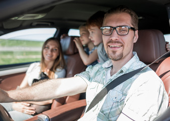 Wall Mural - side view.happy father driving a car