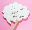 © Tierney - Next level concept with a speech bubble on a pink background